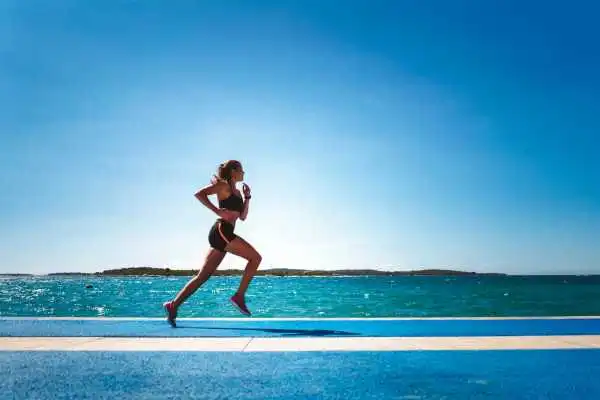 Woman running showing strong leg muscle Gateshead
